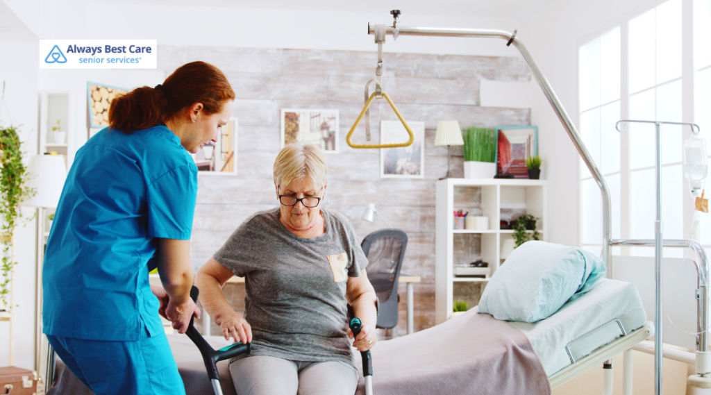 Older woman doing seated leg exercises with hand weights in a bright sunroom.