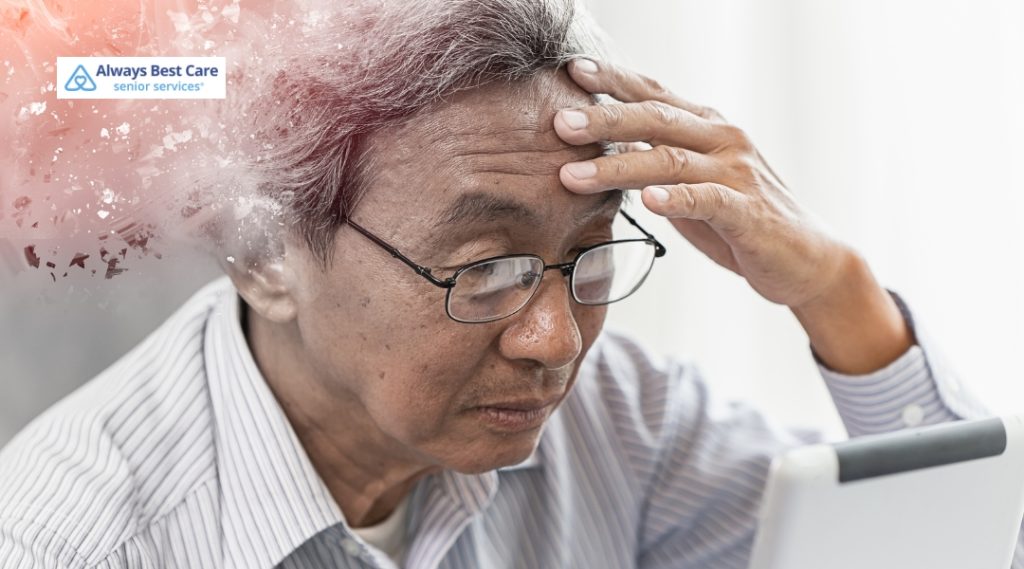 An elderly man wearing glasses and a striped shirt appears confused or concerned, holding his forehead while looking at a tablet. The background has a creative effect that fades from the man's head into a light, scattered particle design.