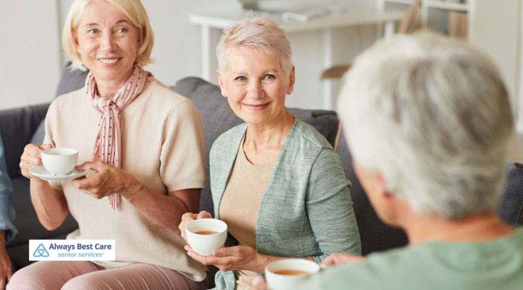 Group of senior women enjoying their time together while drinking tea in a living room.