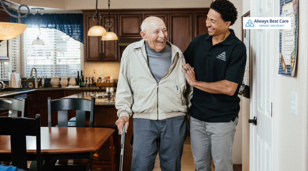 4. Caregiver assisting a senior man using a walker as they move safely through his home.