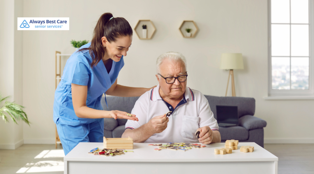 Caregiver assisting an older man with a colorful arts-and-crafts activity.