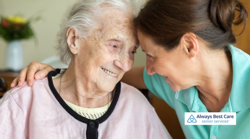 In-home caregiver offering emotional support and companionship to an elderly woman.