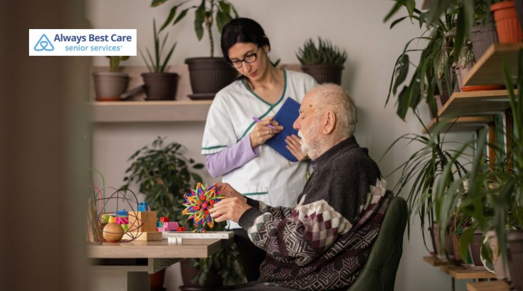 Caregiver assisting an older man with memory activities and cognitive engagement exercises.