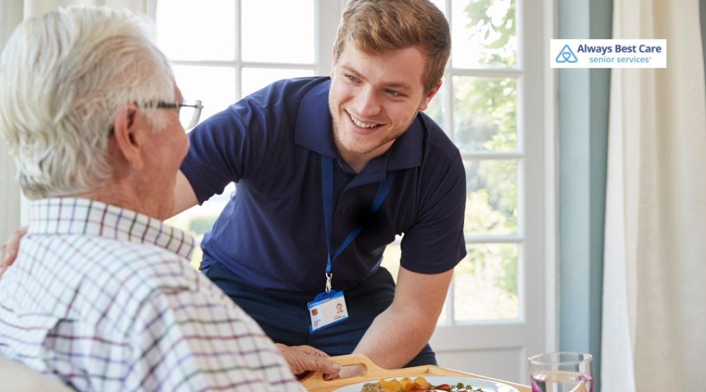 A caregiver assisting a senior man with his meal, providing personalized care and support while ensuring he feels valued.