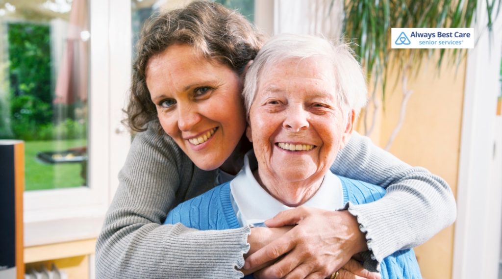 Caregiver helping an elderly man and woman with paperwork, symbolizing professional and caring support for seniors.