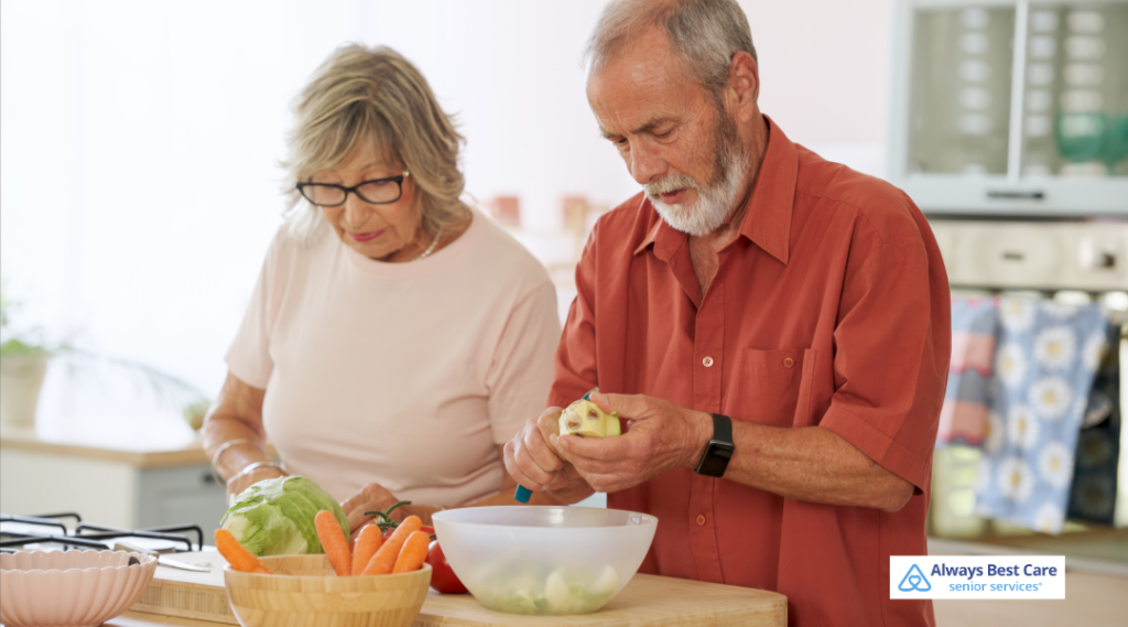 Older couple working side by side to prepare fresh vegetables for a healthy meal at home.