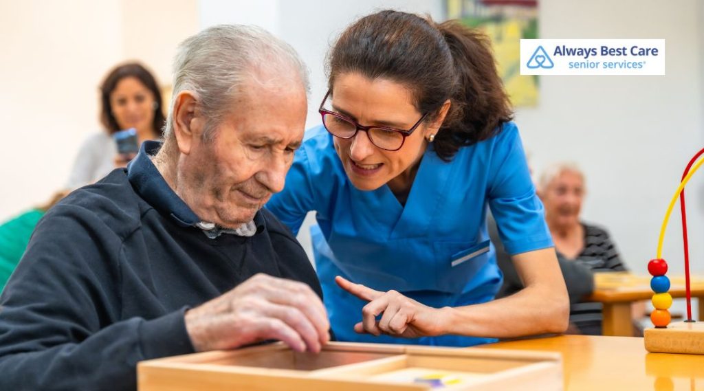 Senior caregiver assisting an elderly man with cognitive therapy and memory support activities.