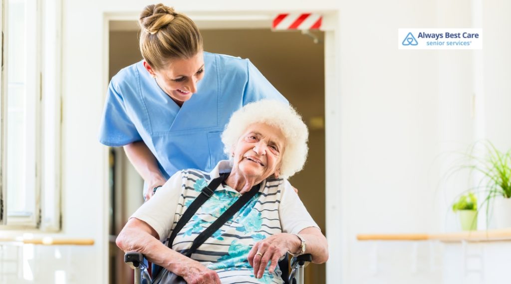 A caregiver helping an elderly woman in a wheelchair with a warm smile, showing attentive care and support in a bright, inviting space.