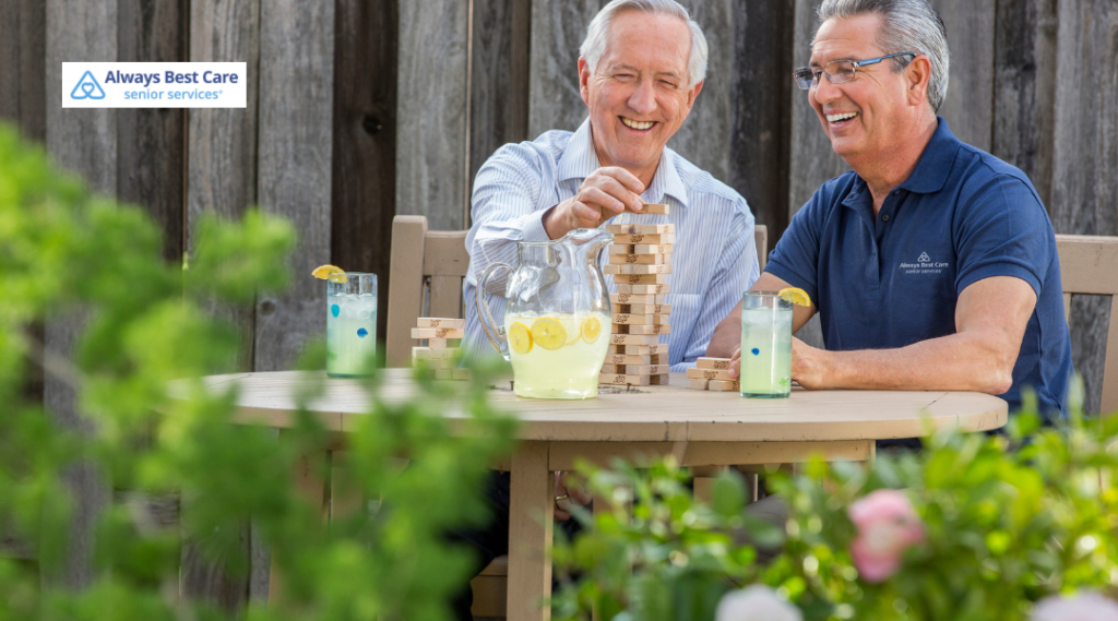 5. Caregiver smiling with an older woman during a meal at home.
