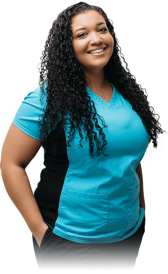 FEMALE CAREGIVER IN BLUE UNIFORM SMILING