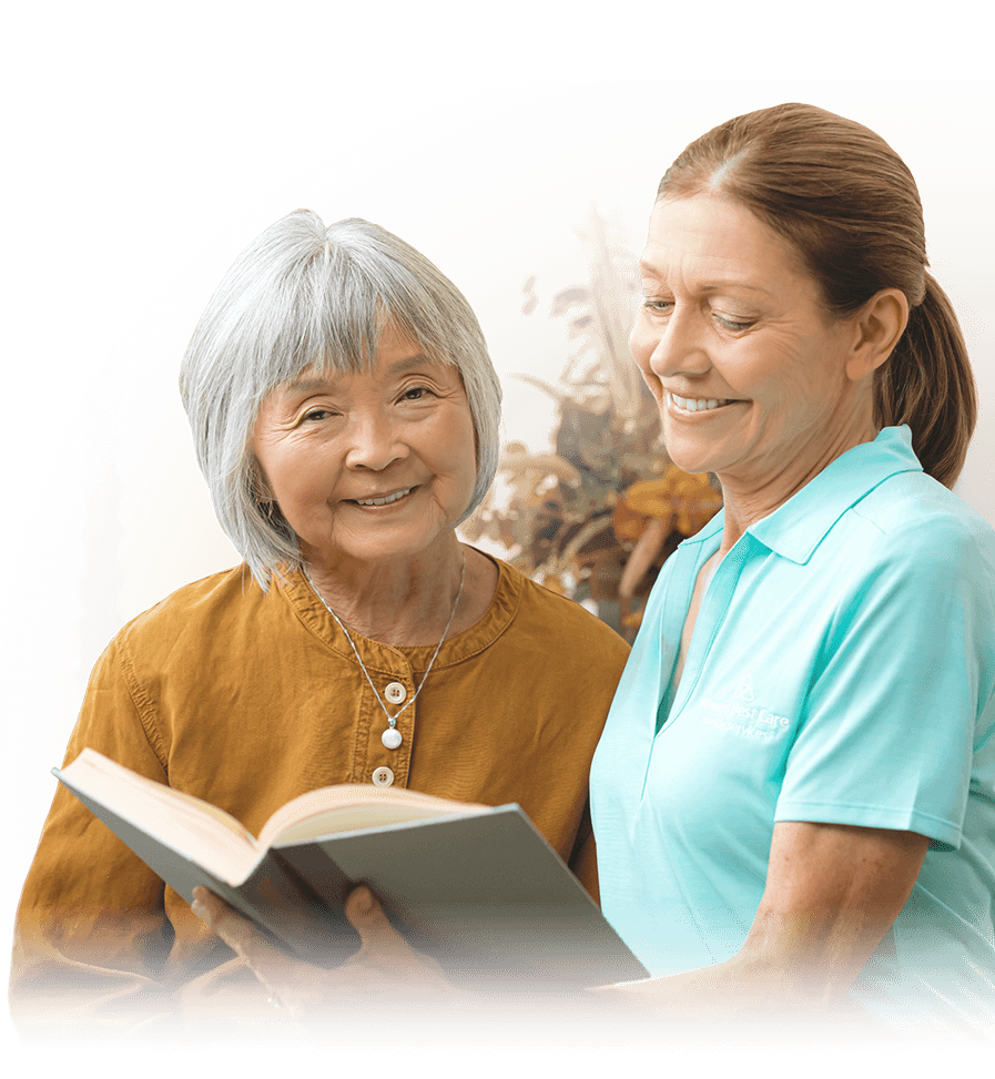 SENIOR WOMAN WITH A CAREGIVER READING A BOOK