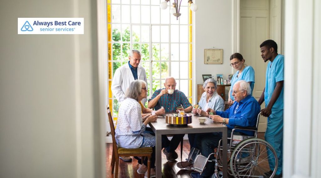 Older adults participating in social activities with caregivers in a senior care community setting.