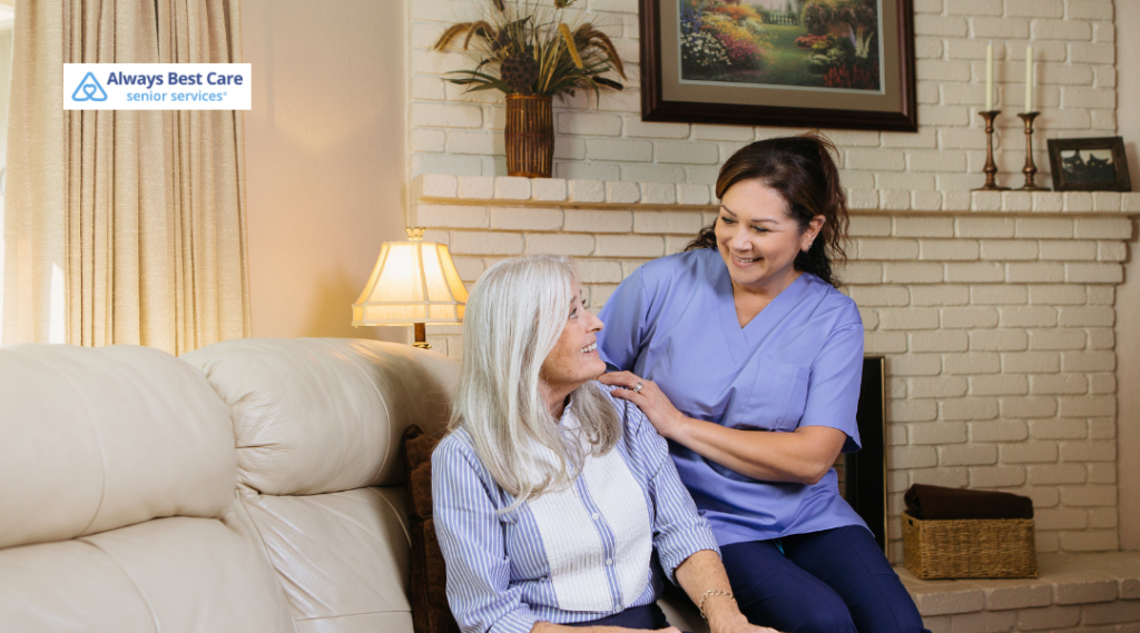 6. Caregiver comforting an older woman on a living room couch.