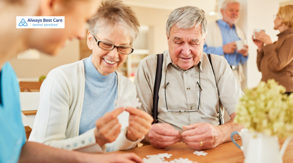 Smiling older adults assembling a jigsaw puzzle together in a group setting.