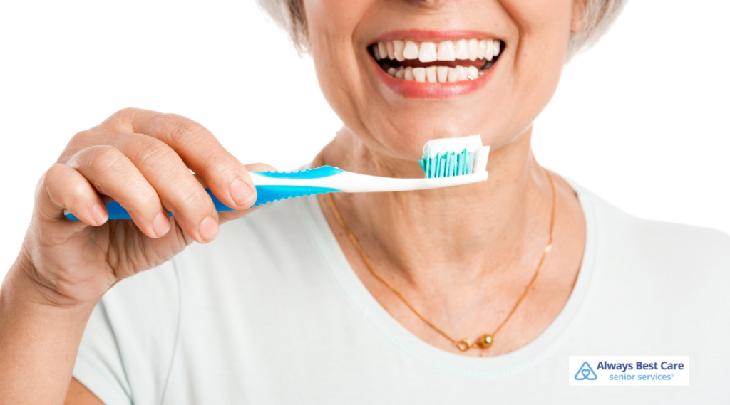 An elderly woman is seen holding a toothbrush.