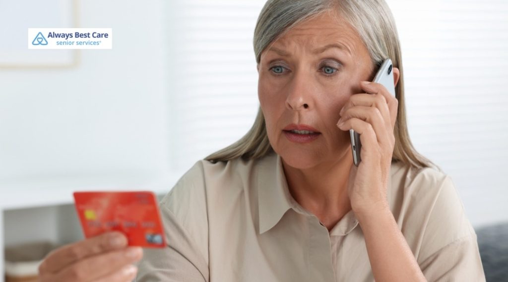 SENIOR SCAMS: HOW TO RECOGNIZE THE WARNING SIGNS AND PROTECT YOUR LOVED ONE IN HOLLYWOOD, FL 3 WORRIED OLDER MAN ON THE PHONE, EXAMINING A BANK CARD WHILE QUESTIONING A SUSPICIOUS CALL.