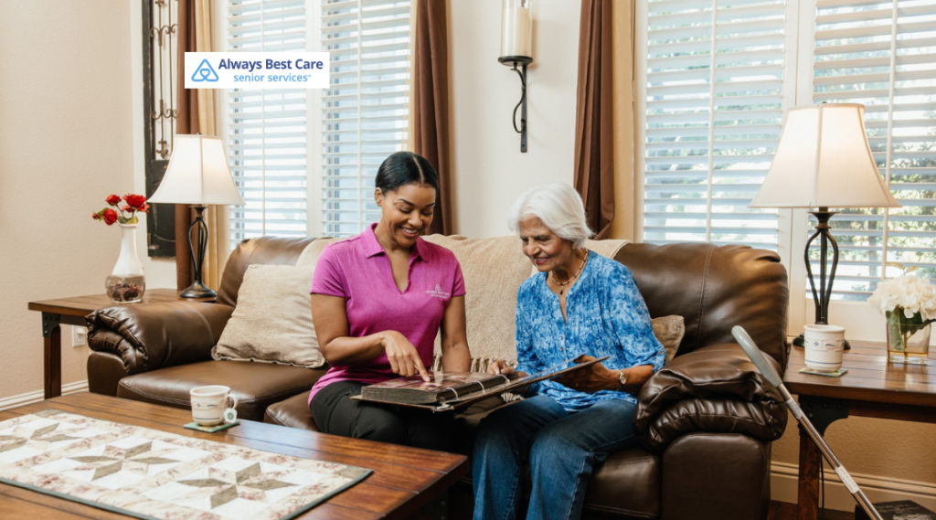 Caregiver and older adult at a kitchen table completing a colorful jigsaw puzzle, showcasing meaningful activities and one-on-one attention through the GUIDE program.