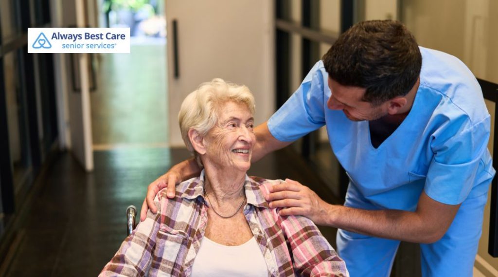 Caregiver supporting an elderly woman using a wheelchair during personalized senior care services.