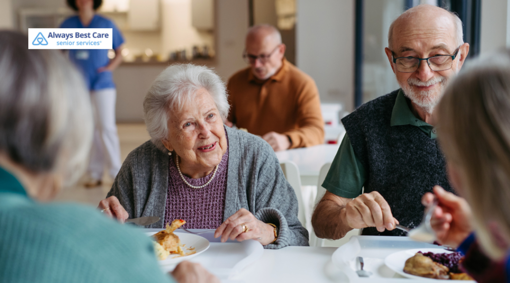 Older couple looking at a tablet together at a kitchen table.