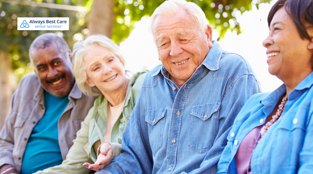 Group of older adults smiling and socializing outdoors.