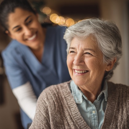 Smiling caregiver supporting a senior woman at home, reflecting trusted home care in Houston, TX focused on comfort and safety.
