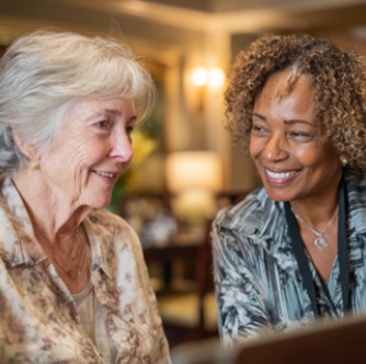 Senior and caregiver sharing a reassuring conversation, reflecting compassionate senior care in Sugar Land, TX families can trust when exploring living options.