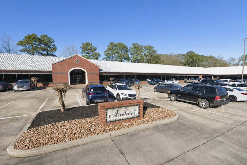 Office exterior for Houston, TX Home Care Services with brick facade, parking lot, and roadside monument sign