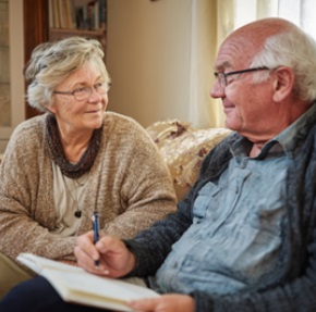 ELDERLY COUPLE DISCUSSING CARE PLANS, ILLUSTRATING HOME CARE SERVICES IN MADISON, WI.