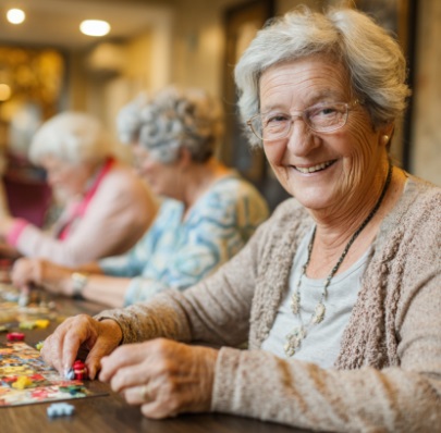 SENIOR WOMAN PARTICIPATING IN A PUZZLE ACTIVITY WITH OTHERS WHILE SUPPORTING MENTAL WELLNESS AND SOCIAL ENGAGEMENT IN FITCHBURG, WI.