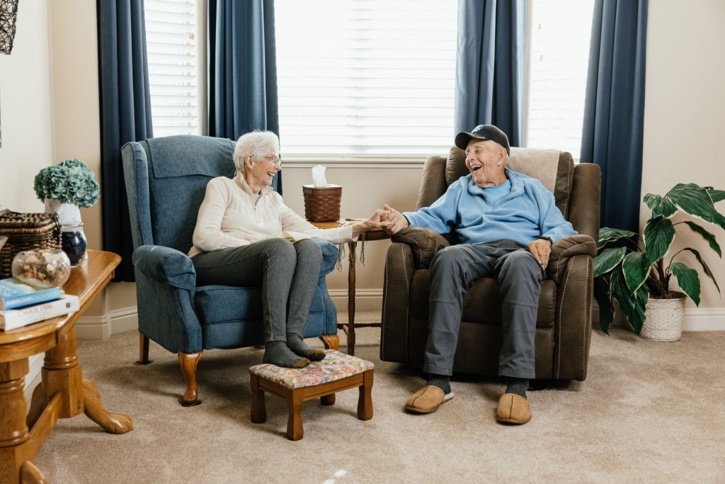 Caregiver driving an older woman to an appointment in a car