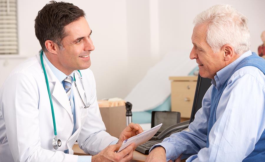 A doctor talking to an elderly man