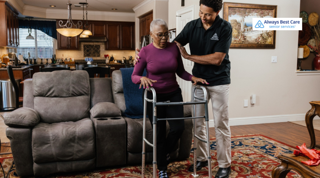 An Always Best Care employee helping an elderly woman on a walker