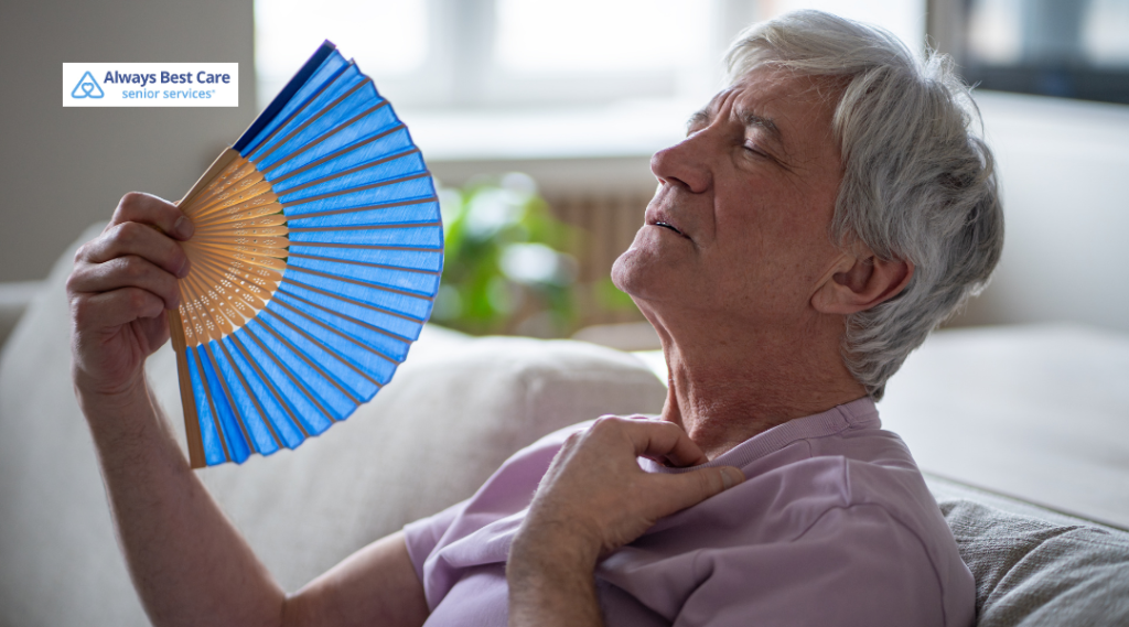 Man fanning himself with a blue fan