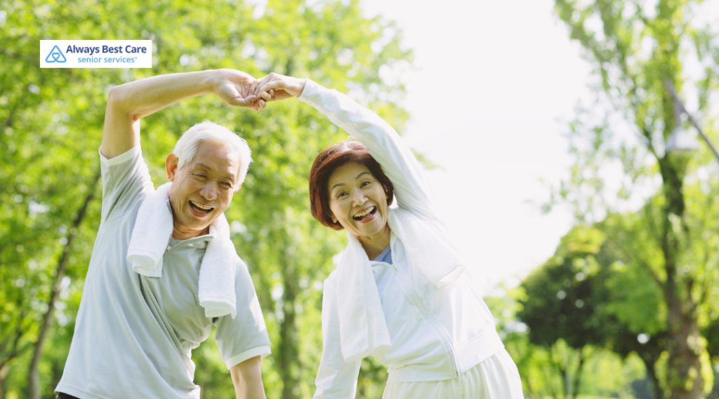 Two seniors forming a heart with their arms in a park
