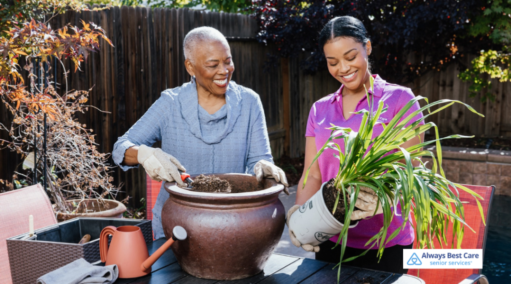 Caregiver assisting a senior with gardening at home, supporting safe and enjoyable outdoor activity.