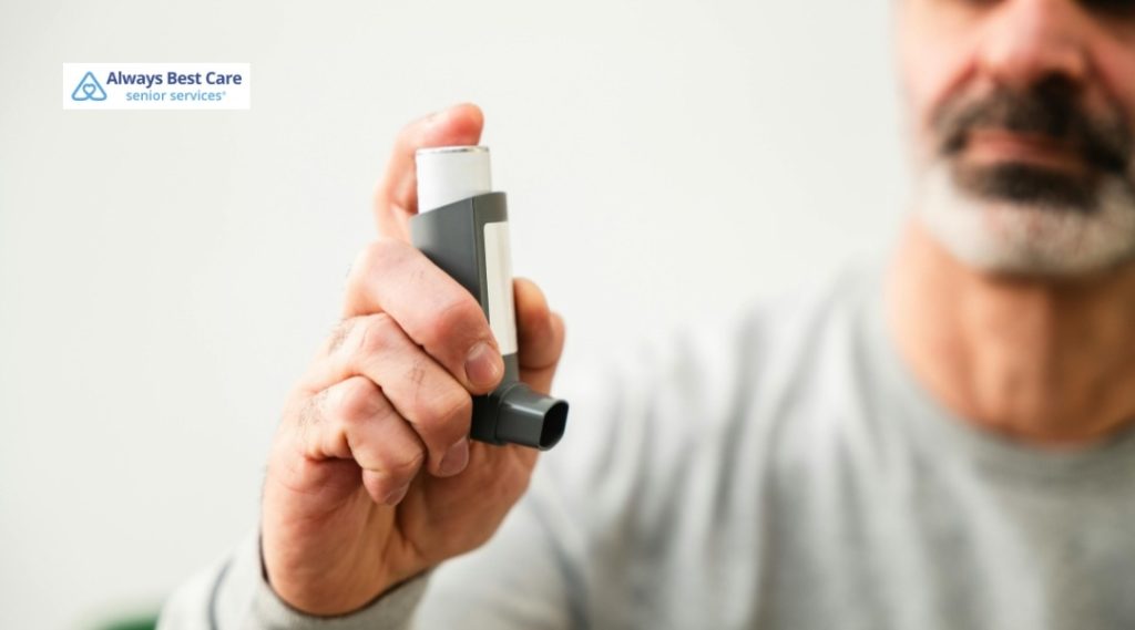 Close-up of a person’s hand holding an inhaler for breathing support against a soft background.
