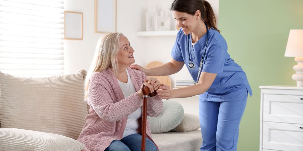 Caregiver assisting an older adult with a cane while providing compassionate home care services in Burbank, CA