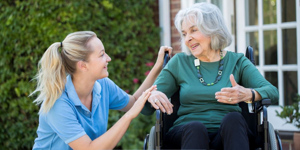 Caregiver providing compassionate support to an older adult in a wheelchair receiving home care services in Burbank, CA