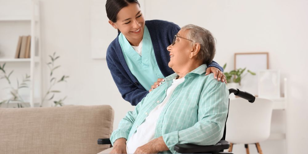 Caregiver providing compassionate support to an older adult in a wheelchair receiving home care services in North Hollywood, CA.