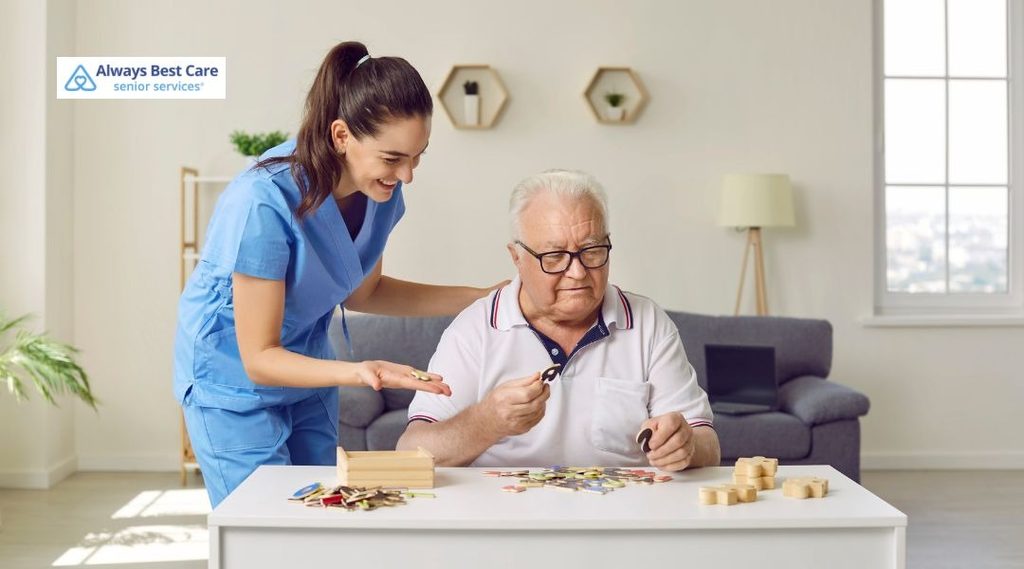 Older couple enjoying a jigsaw puzzle activity with caregiver support in a welcoming home setting.

