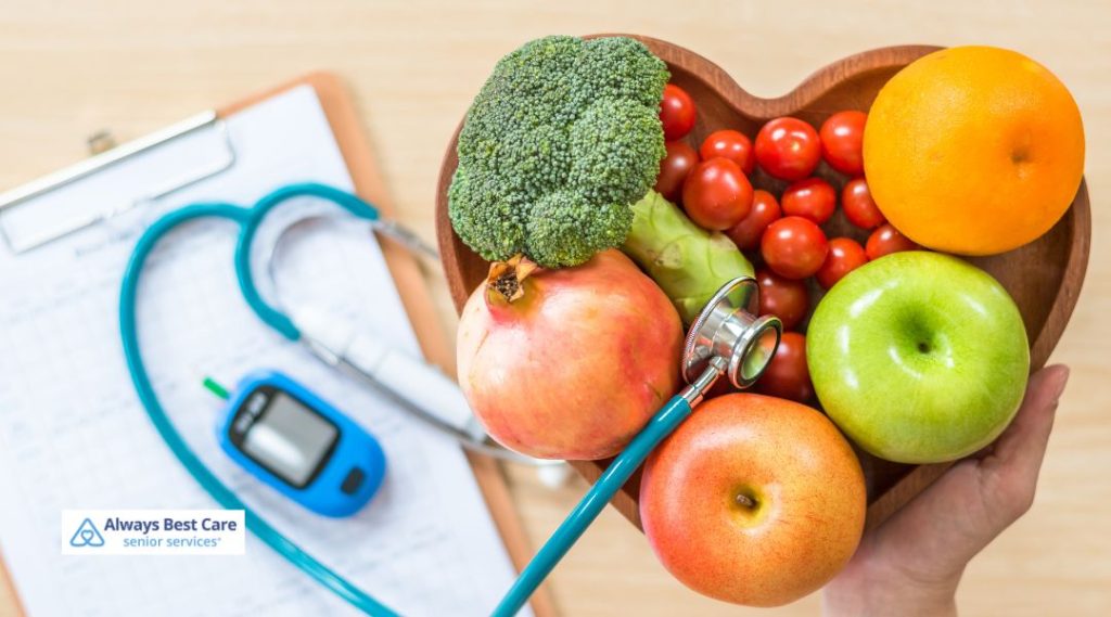 Heart-shaped bowl of fresh fruits and vegetables beside a stethoscope symbolizing heart-healthy nutrition.