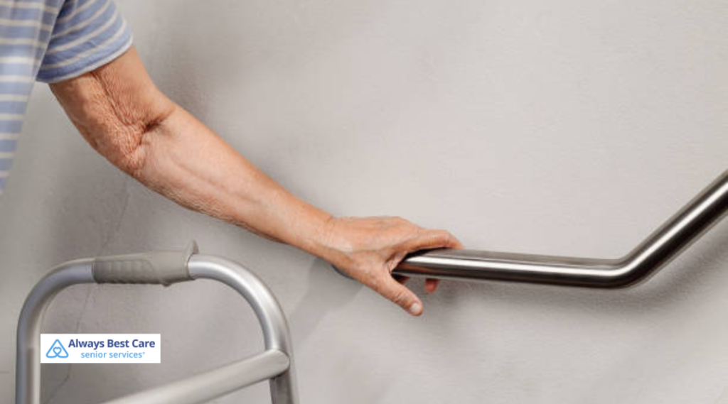a senior's hand grasping a sturdy metal handrail 