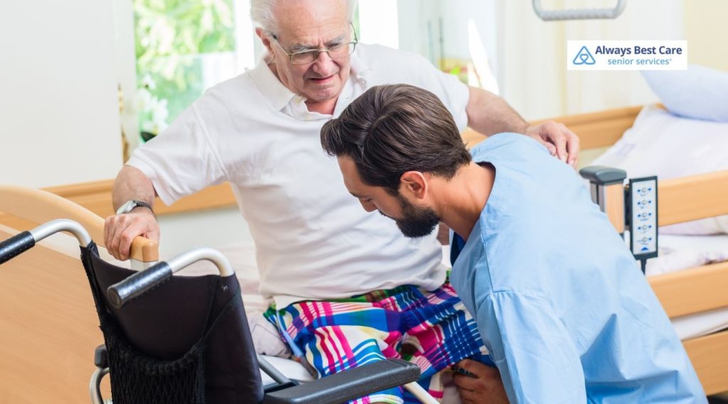 Home care nurse helping a senior woman move comfortably from her wheelchair