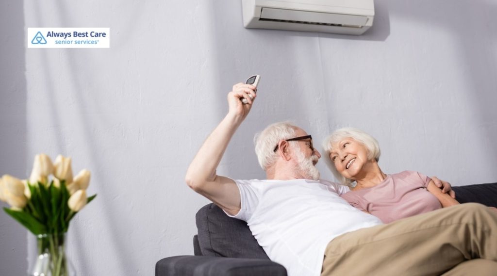 Senior couple relaxing on a couch while smiling together at home.