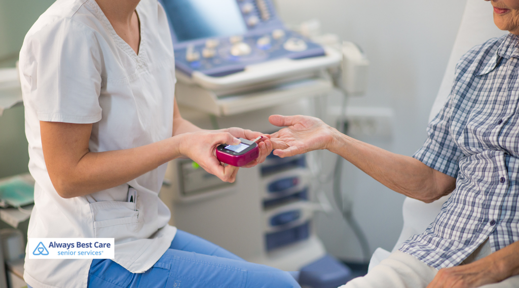 Caregiver using a lancing device to test an older woman’s blood sugar while seated at home.