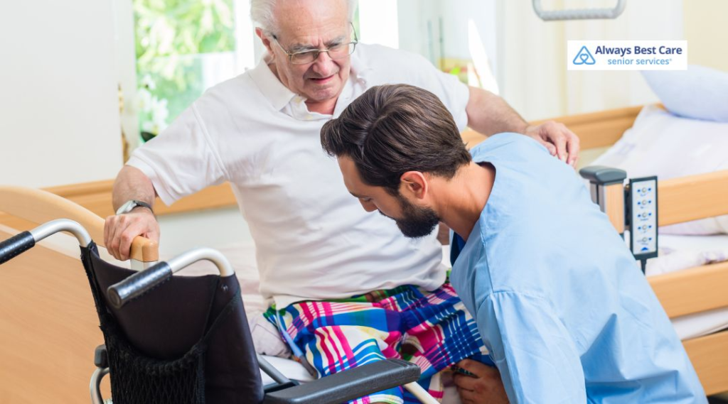A caregiver helping an elderly man get out of a wheelchair while offering support, emphasizing personalized care for mobility challenges.