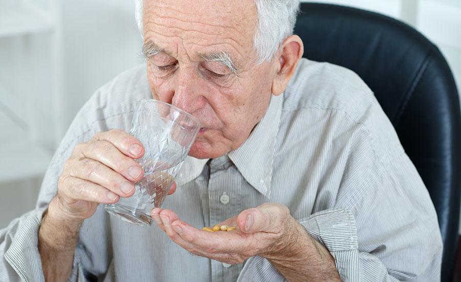 A senior drinking medicine​
