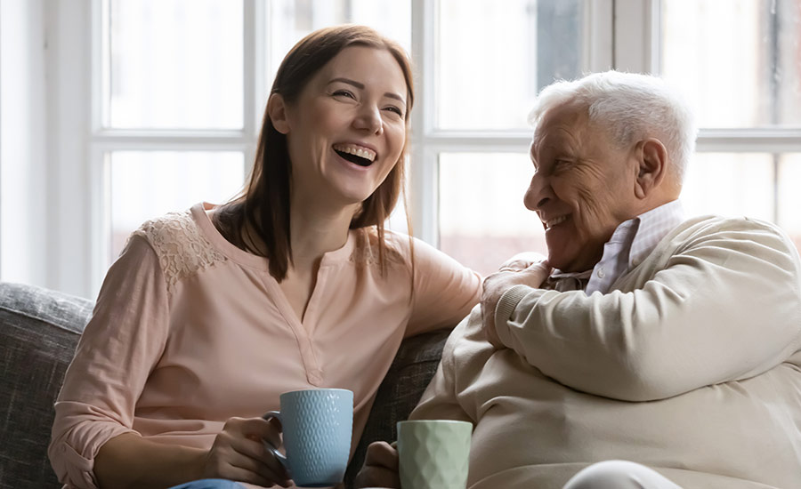  A family caregiver and dementia patient laughing​