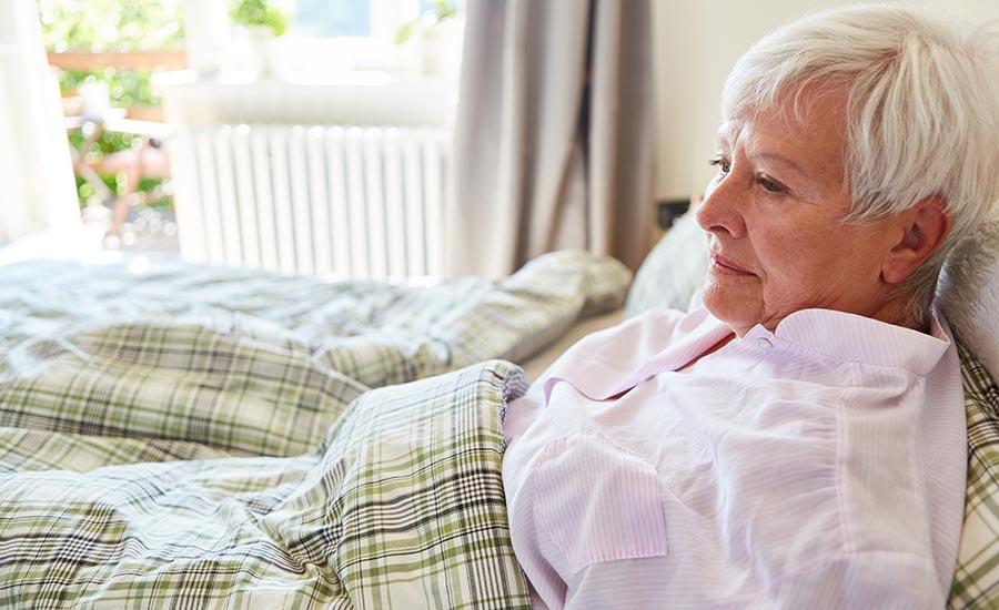 A dementia patient lying on a bed​