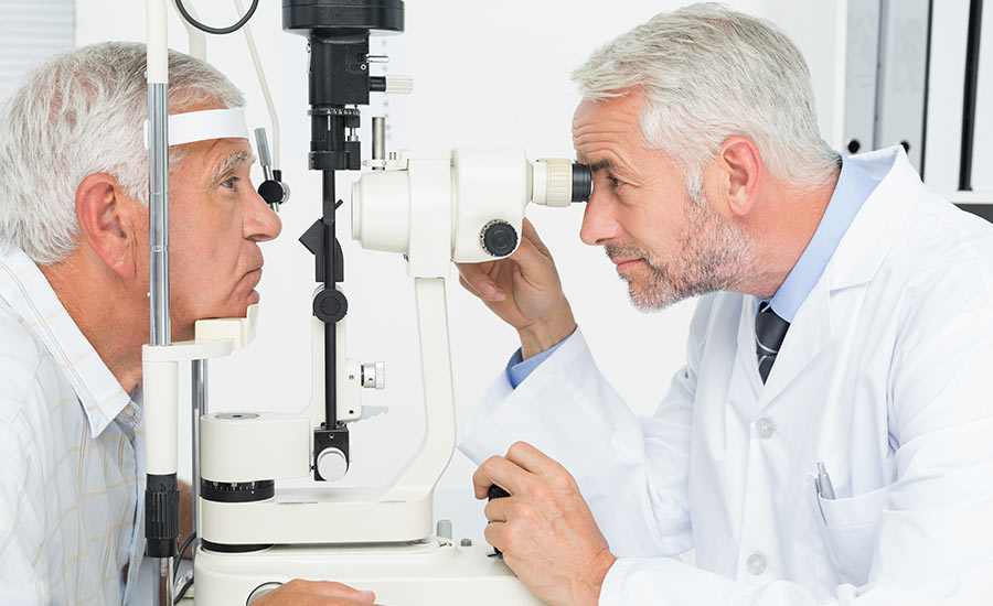 A doctor evaluating a senior man's eyes​